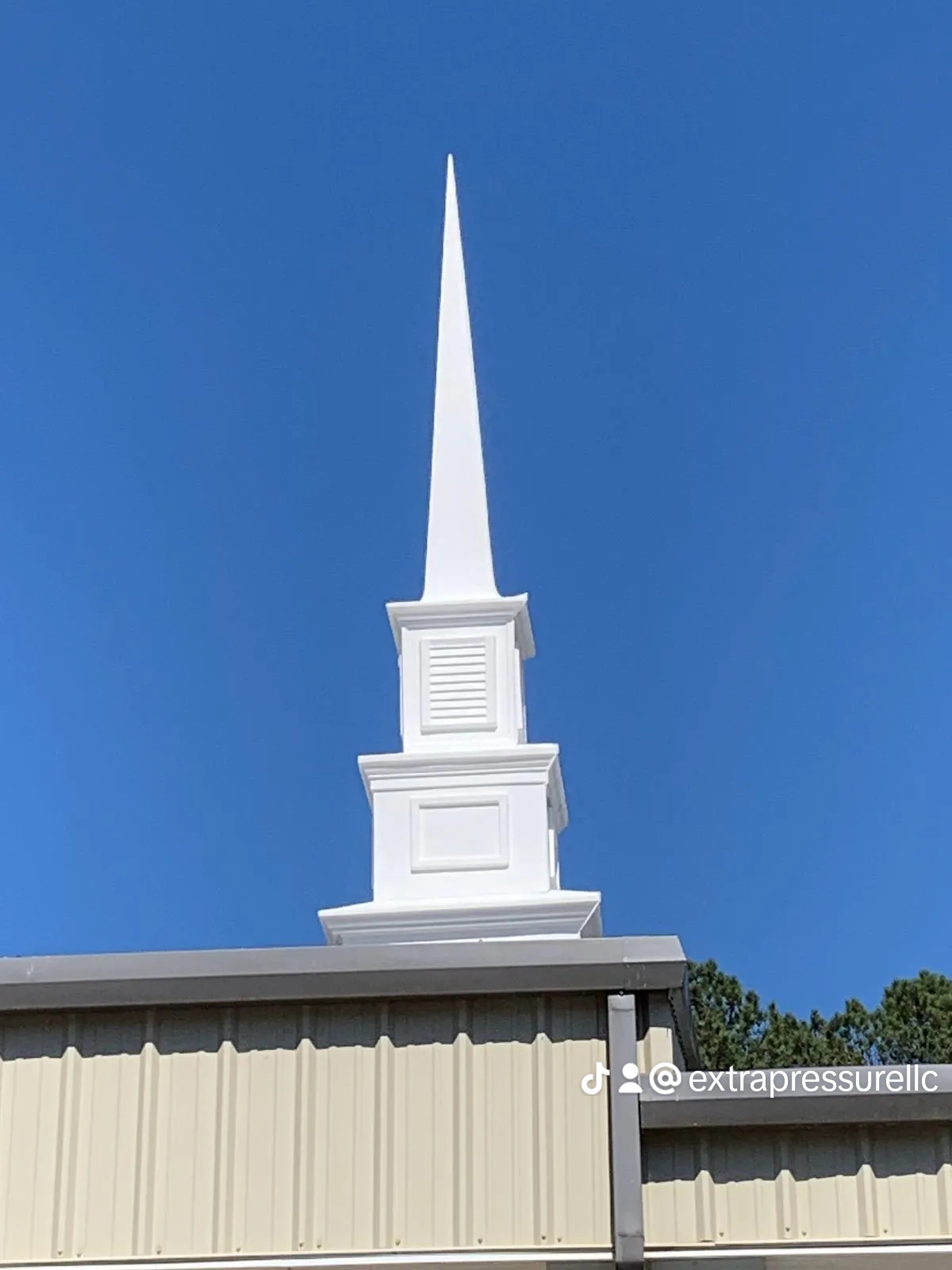 White church steeple against blue sky
